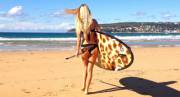 On a leopard print paddle board