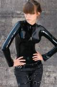 Alexandra Potter in black latex catsuit and jeans