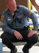 Older cop kneeling