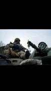 Ukrainian Soldier riding on an APC