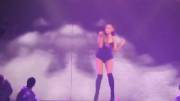 Ariana Grande shaking her ass in high heel boots.