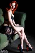 Redhead in heels on a couch