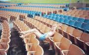 Barefoot and topless in a stadium