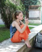 Barefoot backpacker smoking