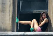 Cute girl in the window with green socks