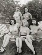 Topless women posing outdoors.
