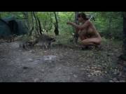 Naked woman feeding raccoon