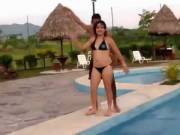 Chubby latina girl having fun and dancing in a pool party