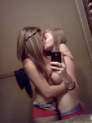 Selfie of topless teens making out.