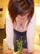 Busty girl tending to her flower