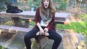 Gingerspyce outside in the park fingering through torn leggings