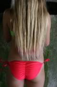 Long blonde hair down to bright pink cheeky bikini bottoms