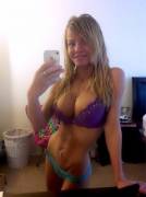 Blonde's selfie shows lots of cleavage in a purple bra